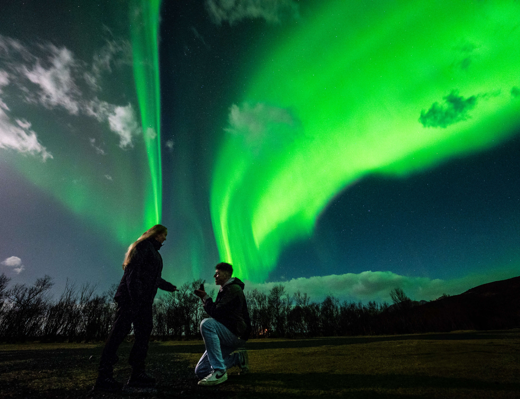 Couple proposing beneath the aurora in Iceland