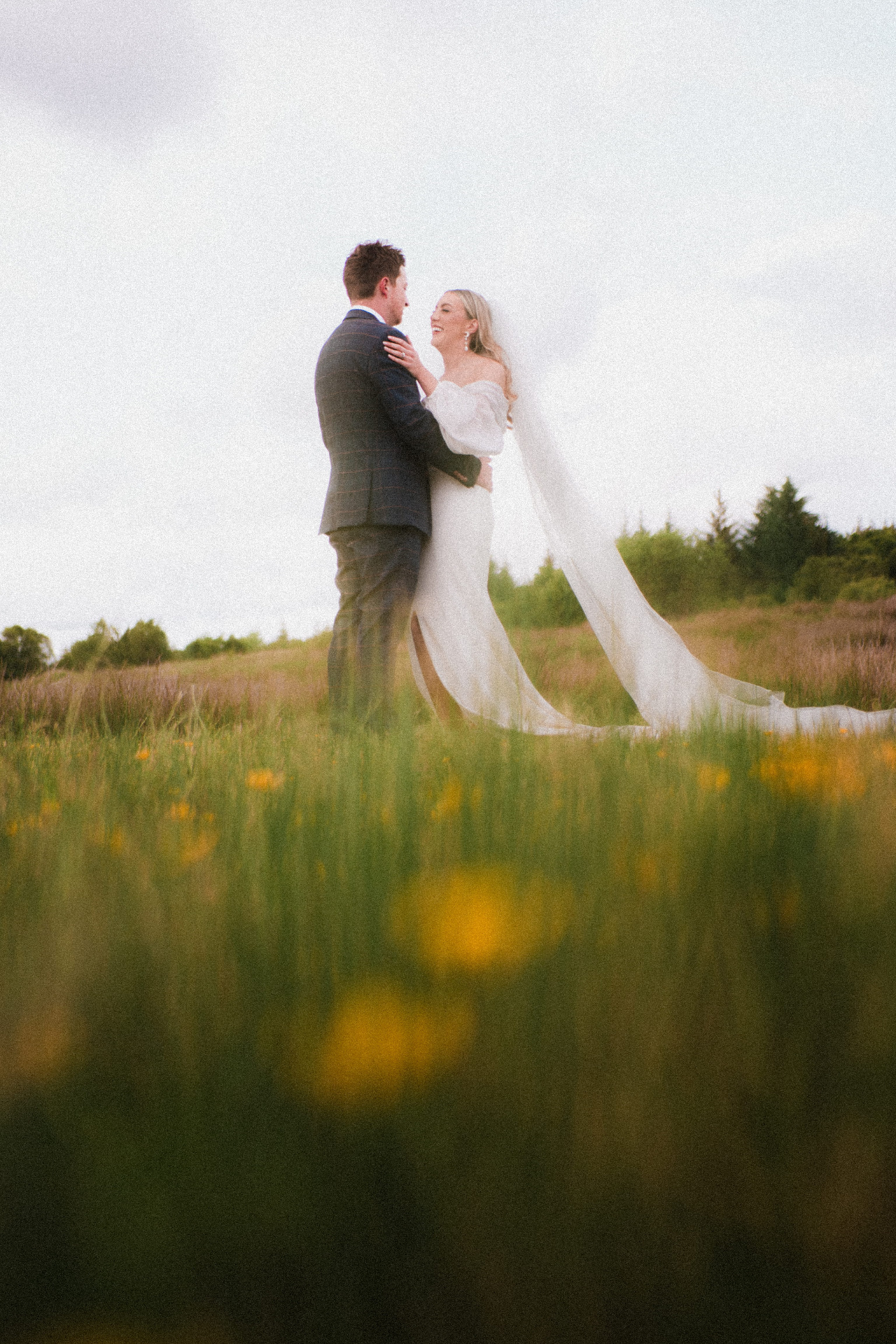 Bride and groom portrait in a wildflower meadow