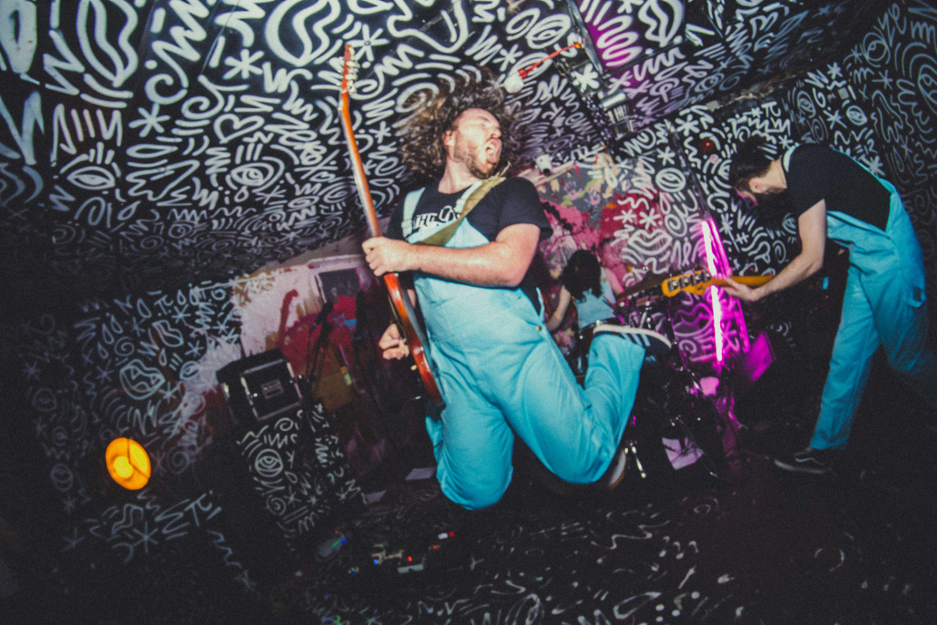 Live band performer mid-jump on stage